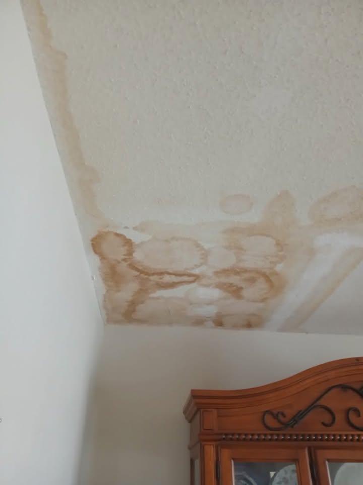 New drywall patch fitted into a ceiling corner with joints taped and coated