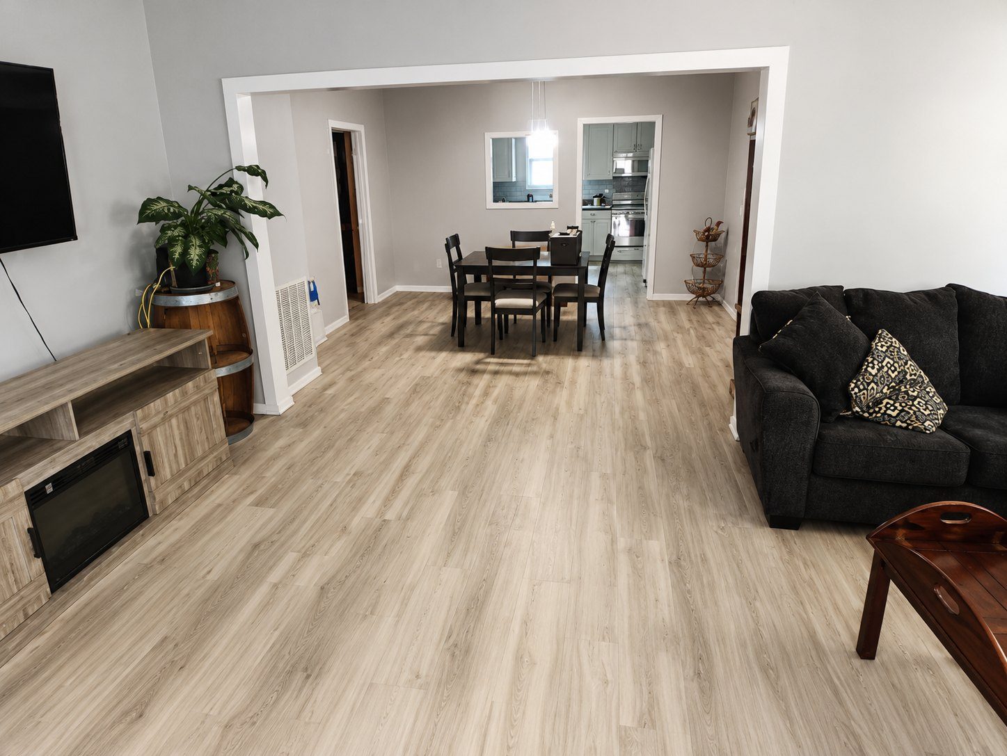 Luxury vinyl plank flooring installed across an open living and dining room